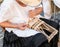 Elderly lady builds hand woven baskets.