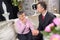 Elderly lady in chapel rest with suited young man