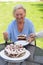 Elderly lady enjoying a slice of cake