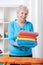 Elderly lady folding towels