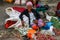 An elderly lady in an interesting hat sells vegetables at the local Indonesian authentic and colorful street market