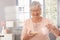 Elderly lady preparing breakfast cereal