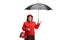 Elderly lady in a red coat holding an umbrella