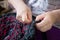 Elderly lady sewing with needle and thread doing hand work