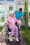 Elderly lady in a wheelchair with her carer.