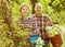 Elderly laughing couple engaged in gardening