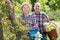 Elderly laughing couple engaged in gardening