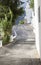 Elderly local man slowly climbing sloped street of Alpujarras to