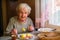 An elderly lone woman portrait dines in his home