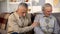 Elderly male comforting senior friend holding hand, loss depression, support