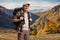 Elderly male hiker with a backpack standing on a mountain