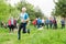 Elderly man an athlete runs on the track at a race among senior athletes