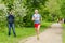 Elderly man an athlete runs on the track at a race among senior athletes