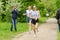 Elderly man an athlete runs on the track at a race among senior athletes