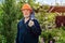 Elderly man with beard in hardhat and glasses with reciprocating saber saw