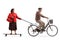 Elderly man on a bicycle pulling an elderly woman on a longboard