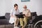 Elderly man browsing photo album while