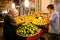 Elderly man buying the lemons and other juicy fruits on the asian street market.