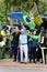 Elderly man with a cane bravely raises the Brazilian flag at the demonstration