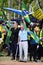 Elderly man with a cane bravely raises the Brazilian flag at the demonstration