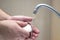 An elderly man carefully washes his hands with soap. Concept of a healthy lifestyle and hygiene