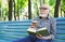 Elderly man in casual reading outdoors