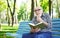 Elderly man in casual reading outdoors