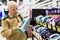 elderly man choosing iron in showroom of electrical appliance store