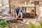 an elderly man cooks barbecue on a grill, a fire.