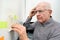 Elderly man with dementia looking at notes