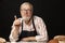 Elderly man demonstrating assortment of bakery. Homemade pastries, rural style