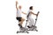 Elderly man and an elderly woman riding exercise bikes with the