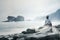 Elderly man enjoying a foggy Papuma beach view