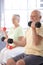 Elderly man exercising with dumbbells