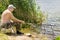 Elderly man fishing on a freshwater lake