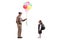 Elderly man giving colorful balloons to an excited schoolgirl