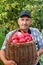 Elderly man with harvesting an apple