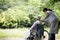 An elderly man and a helper woman in a Japanese wheelchair