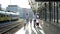 An elderly man with his daughter and little vuchka are walking along the platform. The passengers are holding suitcases