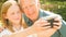 Elderly man and his grand daughter taking selfies