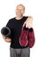 Elderly man holding yoga mattress and sneakers