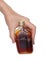 An elderly man holds in his hand the started flat bottle with ch