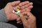 An elderly man holds a lot of colored pills in old hands on a dark background.Identification of pills , learning, e - learning . P