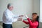 An elderly man hypnotizes a female patient. A woman in a session with a male hypnotherapist during a session. Therapist