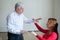 An elderly man hypnotizes a female patient. A woman in a session with a male hypnotherapist during a session. Therapist