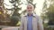 Elderly man in jacket. Old bearded man walking in autumn park