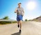 Elderly man jogging on an open asphalt road