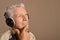 Elderly man listen to music in headphones