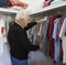 Elderly Man Making Arranging Clothing In Wardrobe.