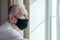 Elderly man in a medical mask. He has the flu. Protecting people around you from the virus. concept of a pandemic. Close up